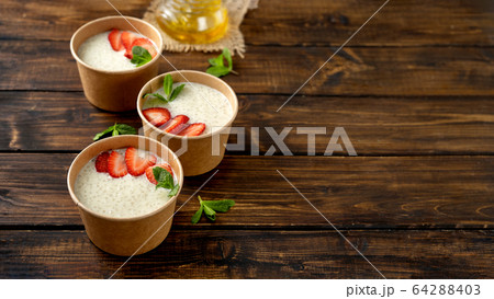 Three craft paper cups with tapioca pudding with plant-based milk Three craft paper cups with tapioca pudding with plant-based milk 64288403