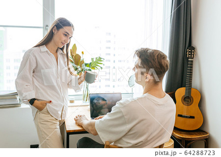 careful wife support her husband while he is working from home careful wife support her husband while he is working from home 64288723