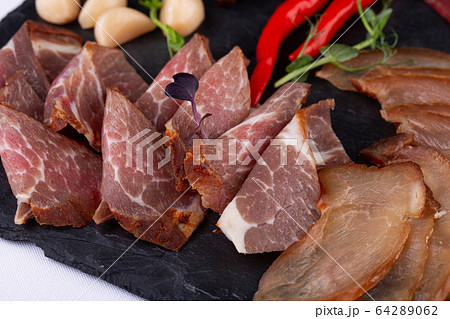 Meat plate of bulk slugged and smoked meat, served with crumbs, garlic and pepper with pickles Meat plate of bulk slugged and smoked meat, served with crumbs, garlic and pepper with pickles 64289062