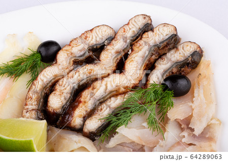 Fish plate with red fish, canned food and halibut, served with lime and dill and olives 64289063