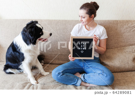 Stay Home Stay Safe. Smiling young woman playing Stay Home Stay Safe. Smiling young woman playing 64289081