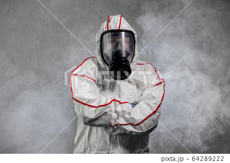 male in protective hazmat suit and gas-mask. pathogen respiratory quarantine coronavirus concept male in protective hazmat suit and gas-mask. pathogen respiratory quarantine coronavirus concept 64289222