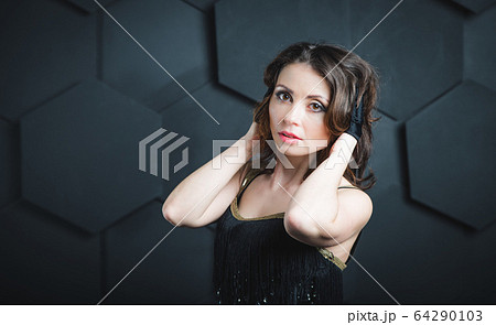 Pretty female magician dressed in performer Pretty female magician dressed in performer 64290103