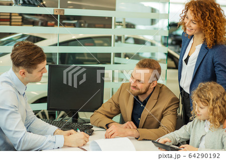 young caucasian couple sign a contract of buying new car 64290192
