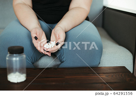 Overweight woman take pills. Medicine and pharmacy Overweight woman take pills. Medicine and pharmacy 64291556