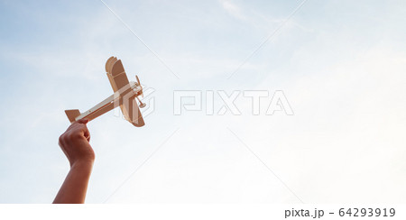 Happy children playing a wooden toy plane On the Happy children playing a wooden toy plane On the 64293919