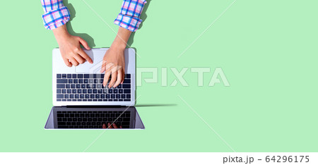 Person using a laptop computer Person using a laptop computer 64296175
