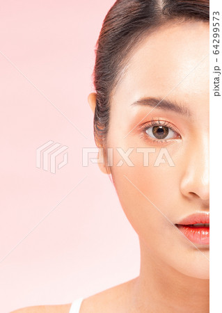 half of Beautiful Asian woman looking at camera smile with clean and fresh skin 64299573