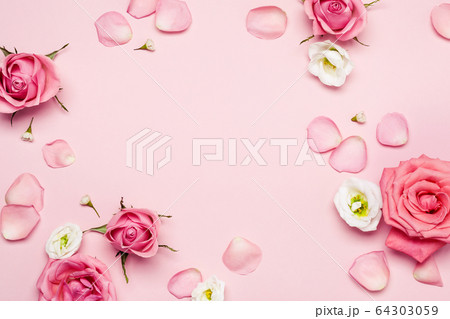 Flower roses frame and petals on pink pastel 64303059