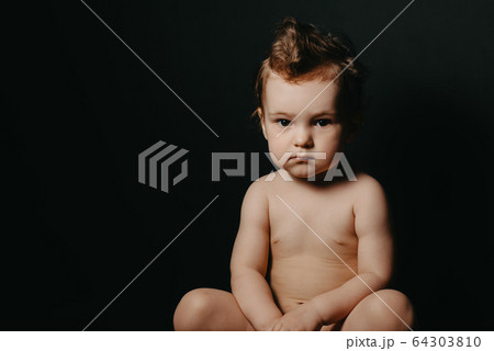 serious child boy sitting on a pot serious child boy sitting on a pot 64303810