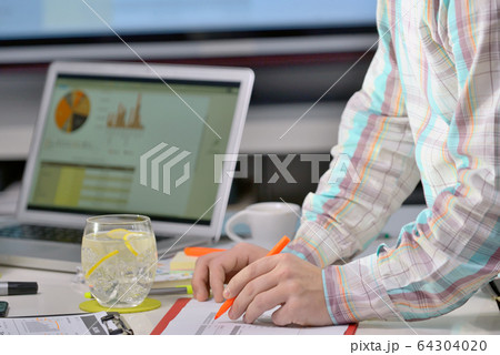Business adviser analyzing financial figures close-up Business adviser analyzing financial figures close-up 64304020