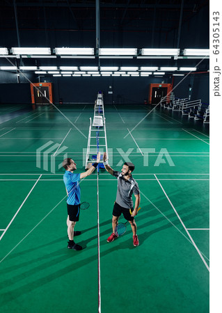 Badminton players giving hign five 64305143