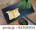 grilled King Oyster Mushroom on a black plate 64306934