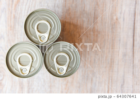 Canned food in metal cans on wooden background , Canned food in metal cans on wooden background , 64307641