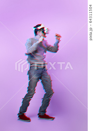 Man with virtual reality headset is playing game and fighting. Image with glitch effect. Man with virtual reality headset is playing game and fighting. Image with glitch effect. 64311504