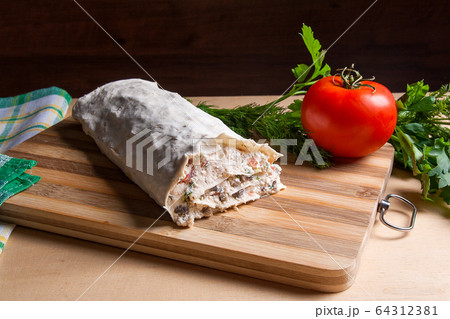 Pita bread or lavash wrapped with cottage cheese Pita bread or lavash wrapped with cottage cheese 64312381
