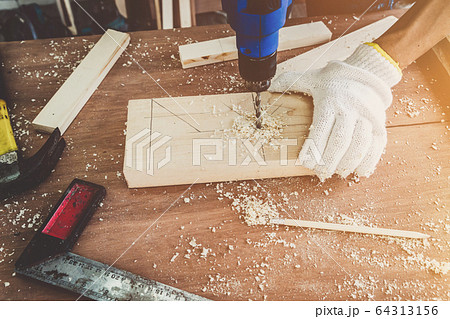 Carpenter working on wood craft at workshop Carpenter working on wood craft at workshop 64313156