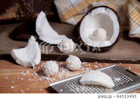 Close up of coconut with white pulp, grater with 64313493