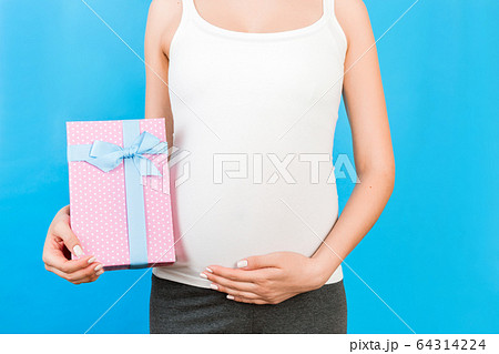 Close up of pregnant woman in home clothing 64314224