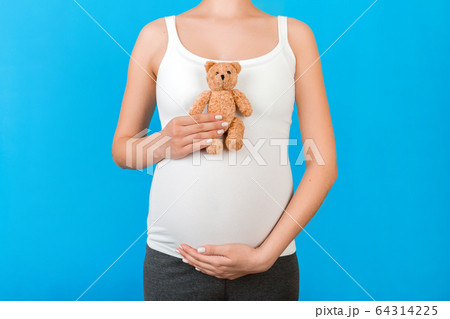 Cropped image of teddy bear in hand against 64314225