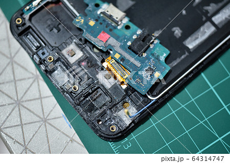 Phone repair, Smartphone damaged from dropping in sea water 64314747