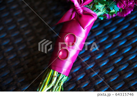rings close up lying on the bridal bouquet 64315746