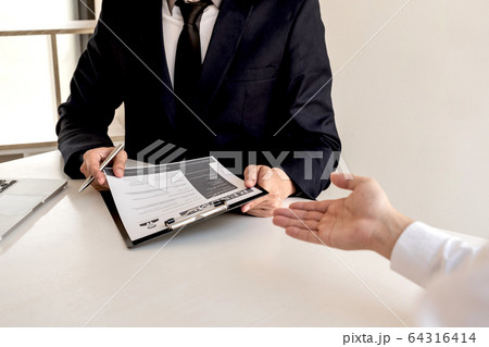 Business people hold a job profile and talk to job 64316414