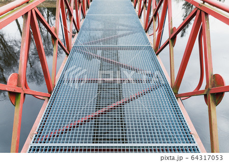 Modern metal bridge view with red handrails Modern metal bridge view with red handrails 64317053