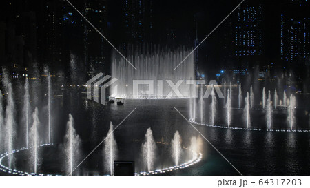 Dancing fountains in Dubai in the evening. 64317203
