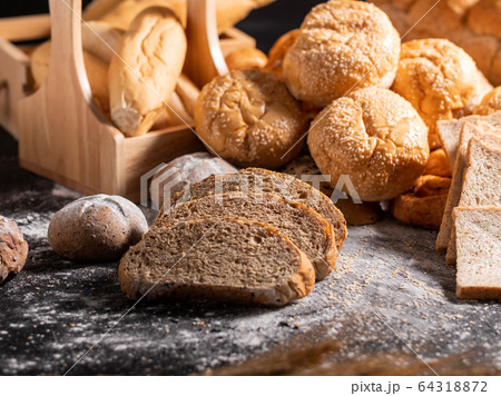 group of bread on the black wooden table with 64318872