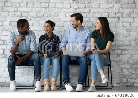 Happy multiracial candidates have fun waiting for interview 64319026