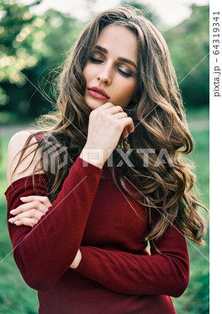 Young sensual woman portrait outdoors on green summer nature background Young sensual woman portrait outdoors on green summer nature background 64319341