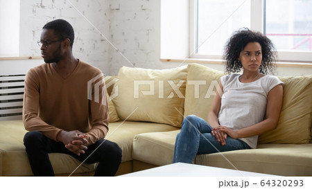 Upset wife feeling guilty after quarrel with African American husband. Upset wife feeling guilty after quarrel with African American husband. 64320293