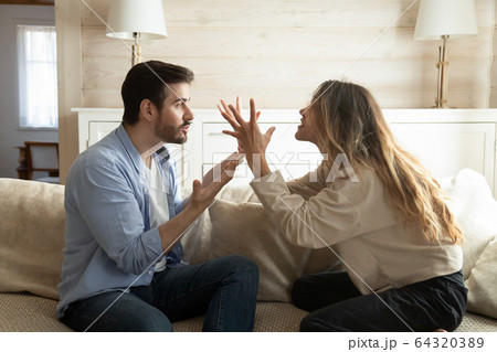 Emotional annoyed stressed couple arguing at home. 64320389