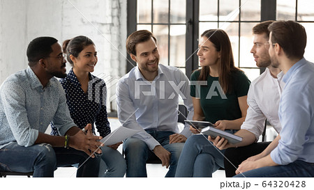 Smiling multiracial colleagues engaged in teambuilding in office 64320428