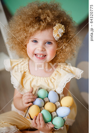 little blonde girl in a yellow suit for Easter little blonde girl in a yellow suit for Easter 64320775