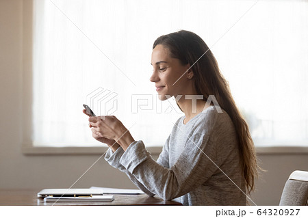 Pleasant mixed race woman chatting with friends in social networks. Pleasant mixed race woman chatting with friends in social networks. 64320927