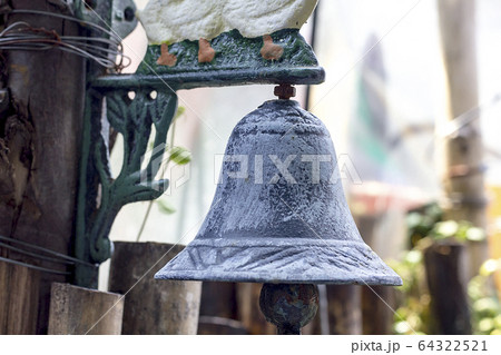 Old bells hanging from the wall 64322521