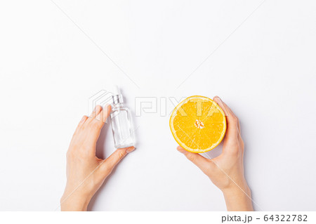Woman's hands holding bottle cosmetic serum 64322782