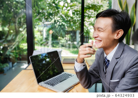 Young businessman laughing with a colleague. Young businessman laughing with a colleague. 64324933