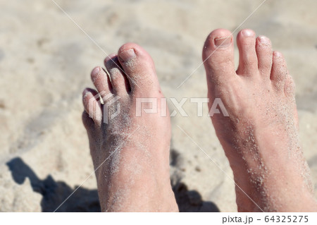 a pair of feet in the sand a pair of feet in the sand 64325275