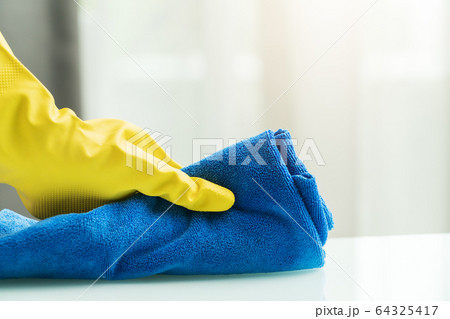 Covid-19 Coronavirus disinfection of home with alcohol, rubber hand glove with micro fiber wipe home 64325417
