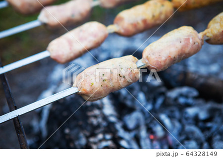 Delicious sausages on a skewer. Rest, friends, Delicious sausages on a skewer. Rest, friends, 64328149