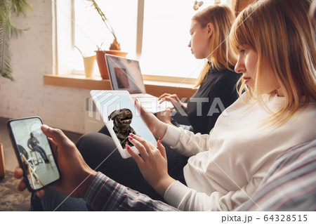 Young friends, women using gadgets to watch cinema, photos, online courses, taking selfie or vlog 64328515
