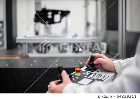 Quality engineer measuring some moldings by professional 3D measuring system machine, industrial concept 64329211