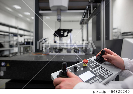 Quality engineer measuring some moldings by professional 3D measuring system machine, industrial concept 64329249