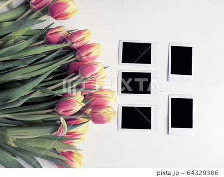 Red and yellow tulips with number eight. Top view of the white background of the spring composition. 64329306