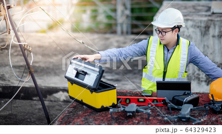 Asian engineer man using drone for site survey 64329423