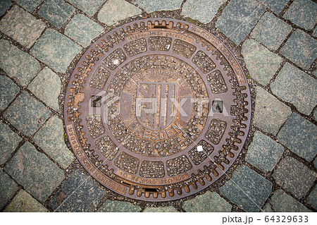 Round Iron hatch for sewer on cobblestone Round Iron hatch for sewer on cobblestone 64329633