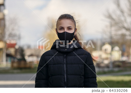 Woman wearing face mask because of Air pollution or virus epidemic in the city Woman wearing face mask because of Air pollution or virus epidemic in the city 64330206